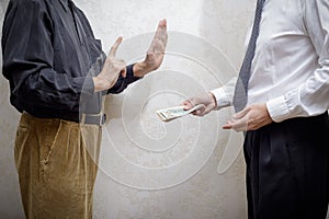 Man Offering a Dollars bribe to a Man Refusing it