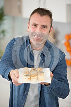 man offering pastry appetizers