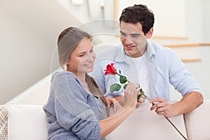 Man offering a rose to his fiance