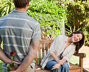 Man offering a rose to his wife