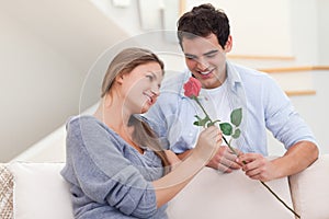 Man offering a rose to his wife