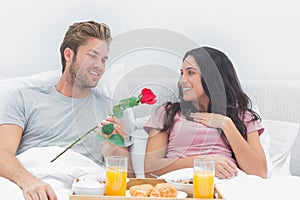 Man offering a rose to his wife