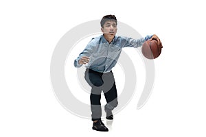 Man in office clothes playing basketball on white background. Unusual look for businessman in motion, action. Sport