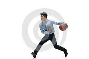 Man in office clothes playing basketball on white background. Unusual look for businessman in motion, action. Sport