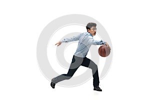 Man in office clothes playing basketball on white background. Unusual look for businessman in motion, action. Sport