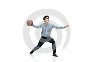 Man in office clothes playing basketball on white background. Unusual look for businessman in motion, action. Sport