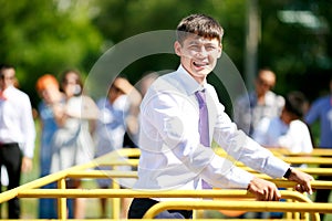 Man in office clothes with tie overcomes sports equipment outdoors. photo