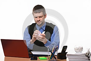 Man in the office clumps a piece of paper on a white background