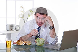 Man at office eat green salad