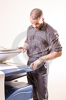 Man in office making copies using photocopier