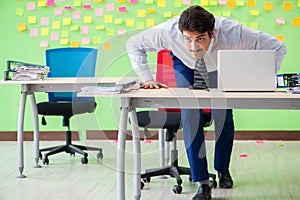 Man in the office with many conflicting priorities doing exercis