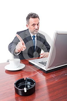 Man at office showing no to smoking