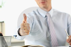 Man in the office shows ok gesture, close-up