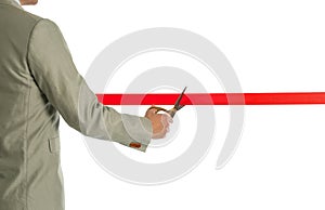 Man in office suit cutting red ribbon, closeup