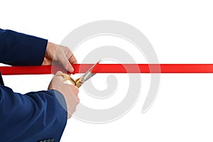 Man in office suit cutting red ribbon isolated on white