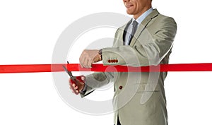Man in office suit cutting red ribbon isolated on white