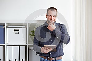 Man in office with tablet computer
