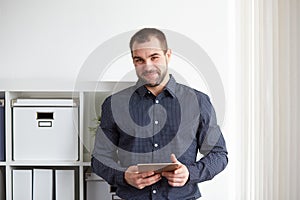 Man in office with tablet