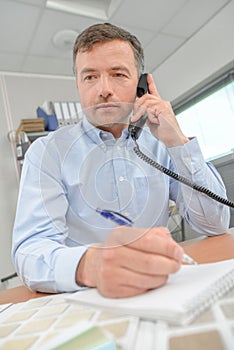 Man in office on telphone