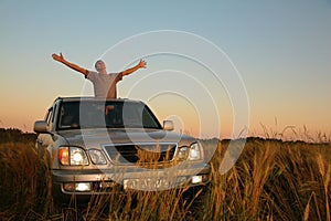 Man with offroad car in field photo