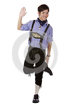 Man with Oktoberfest leather trousers is dancing