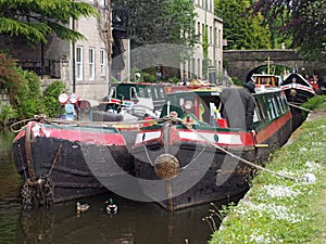 a man on the old barges at the narrow boats club gathering held on the may bank holiday on the rochdale canal at hebden bridge in