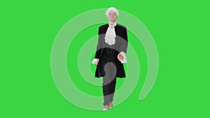 Man in old-fashioned laced frock coat and white wig walking in a mannered way looking at camera on a Green Screen