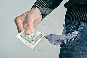 Man with only one US dollar in his pocket photo