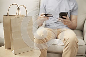Man online shopping using smartphone and credit card e wallet
