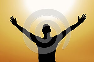 Man with open arms on yellow background