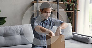 Man open parcel sincerely glad online shop purchased goods