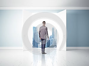 Man in opened doors looking at city