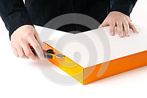 Man opening a box with a cutter