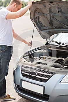 Man opening car bonnet