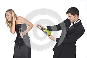 Man opening a champagne bottle at a party
