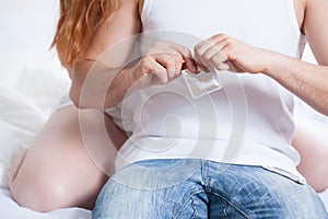 Man opening a condom