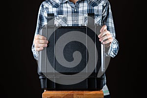 a man opening the dark heavy protective suitcase