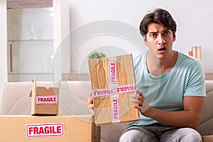 The man opening fragile parcel ordered from internet