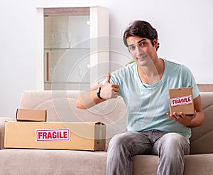 Man opening fragile parcel ordered from internet