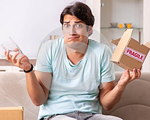 Man opening fragile parcel ordered from internet