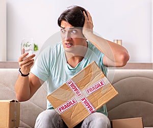 Man opening fragile parcel ordered from internet