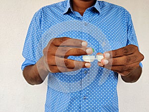 Man opening his contact lens box.