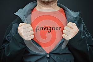 Man opening jacket showing word FOREIGNER