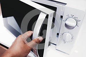 Man opening microwave oven