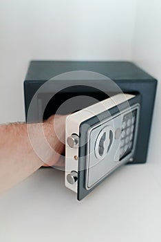 Man opening small safe