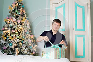 Man opens a Christmas gift