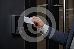 A man opens the door with a card. Modern electronic lock. Keyless Entry photo