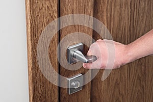 The man opens the door. Close - up of hand and door handle