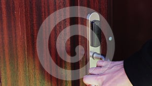 The man opens the door to an electronic key - card