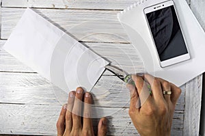 Man opens the envelope with a knife in the workplace.